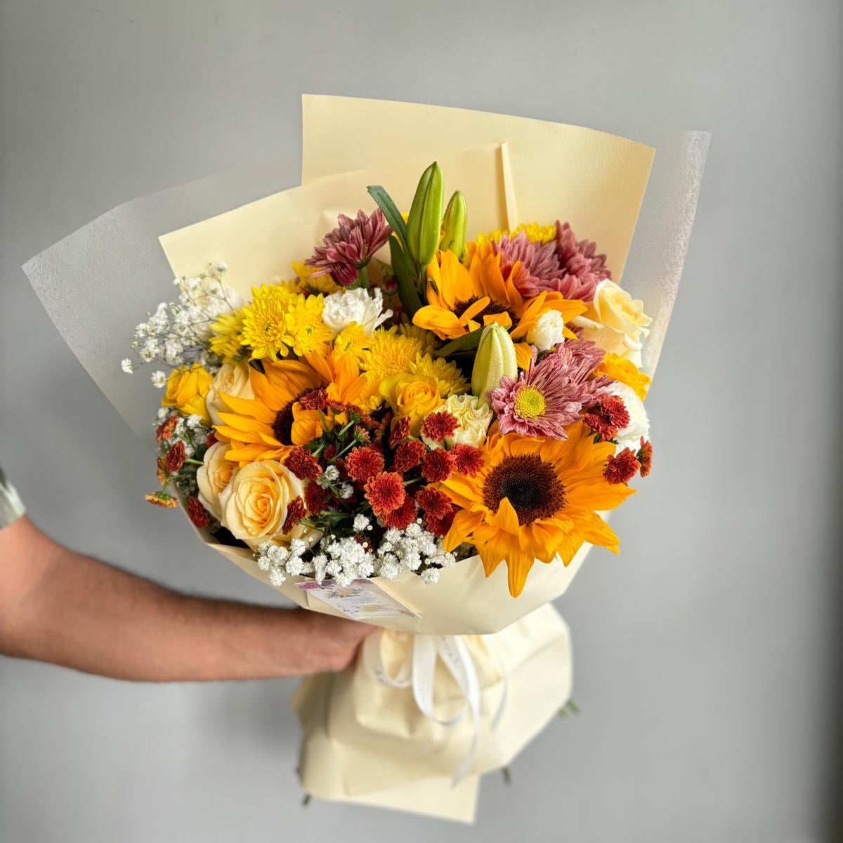 "A vibrant bouquet of colorful roses in full bloom, with shades of red, yellow, and pink."