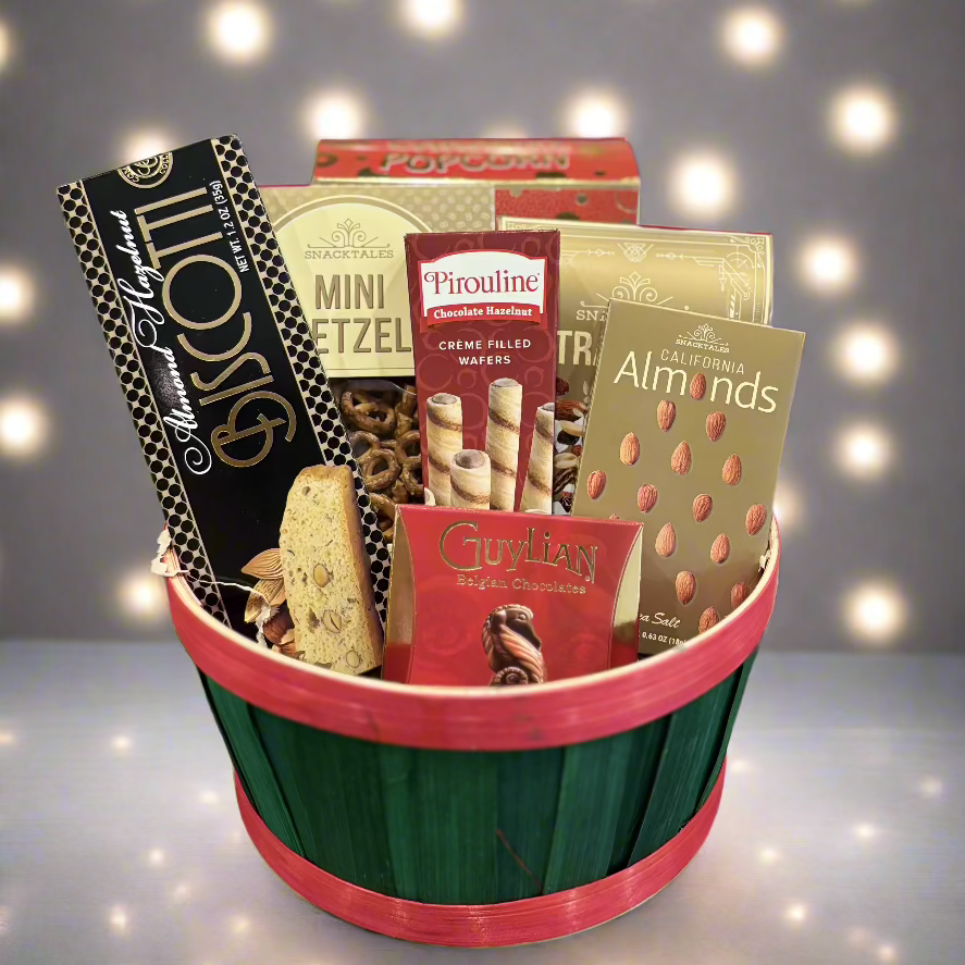A beautifully arranged gift basket filled with gourmet snacks, artisanal chocolates, and refreshing beverages, wrapped in cellophane with a decorative bow.