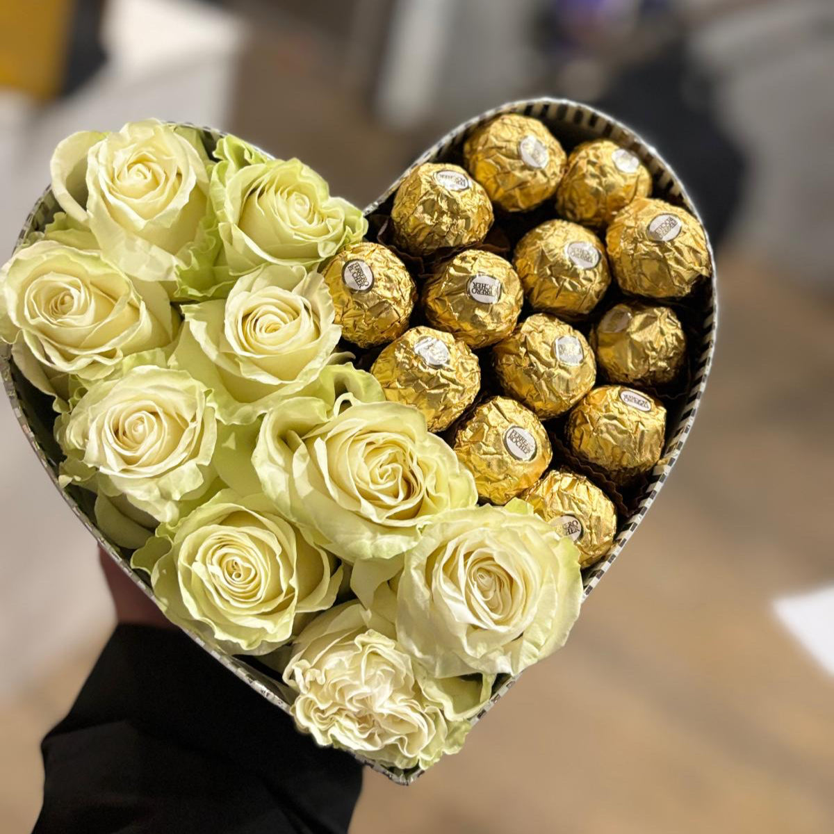 A luxurious gift box featuring fresh white roses and Ferrero Rocher chocolates. The elegant white roses are paired with golden-wrapped Ferrero Rocher chocolates, creating a perfect blend of beauty and indulgence for a romantic gesture
