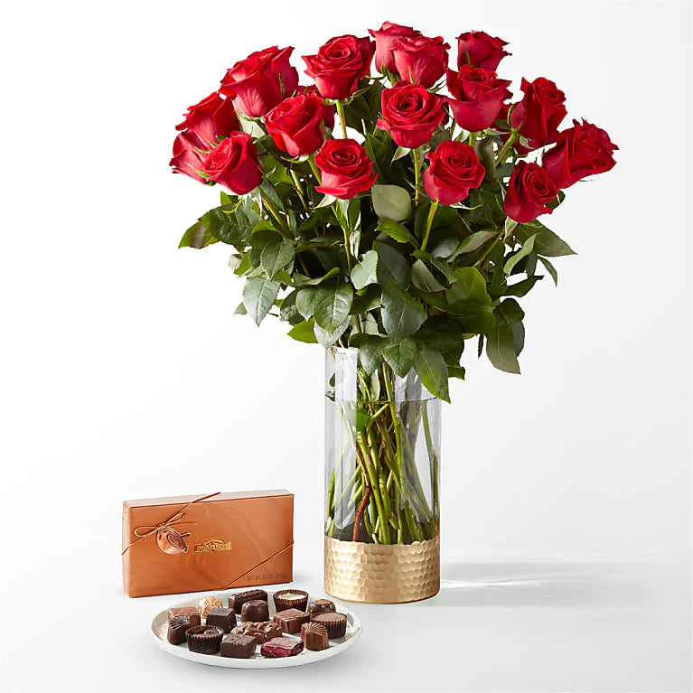 Fresh long-stemmed red roses arranged in a sleek vase, creating a stunning centerpiece for any occasion.