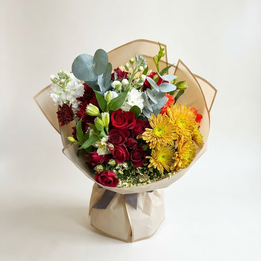 Bouquet of flowers wrapped in brown paper on a white background