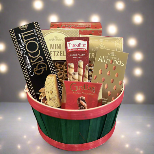 A beautifully arranged gift basket filled with gourmet snacks, artisanal chocolates, and refreshing beverages, wrapped in cellophane with a decorative bow. 