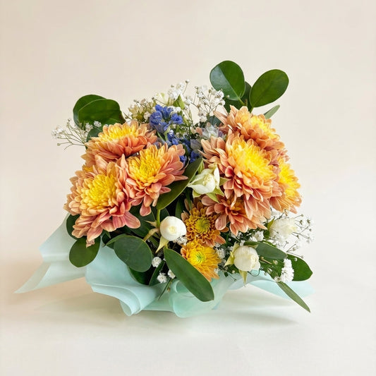 Bouquet of flowers with greenery on a light background