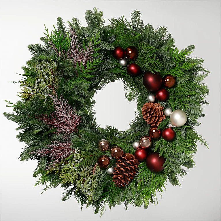 0-inch Christmas wreath featuring green foliage, pinecones, and red berries, perfect for holiday decor on doors, windows, or as a centerpiece