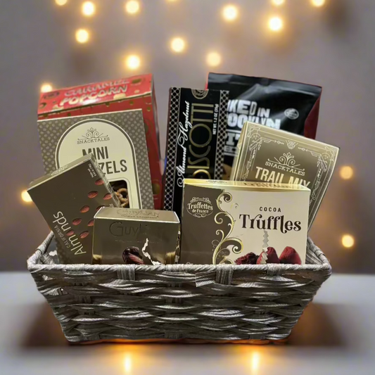 Sweet and savoury gift basket filled with chocolates, caramels, gourmet nuts, crackers, and cheeses, beautifully arranged in a rustic woven basket