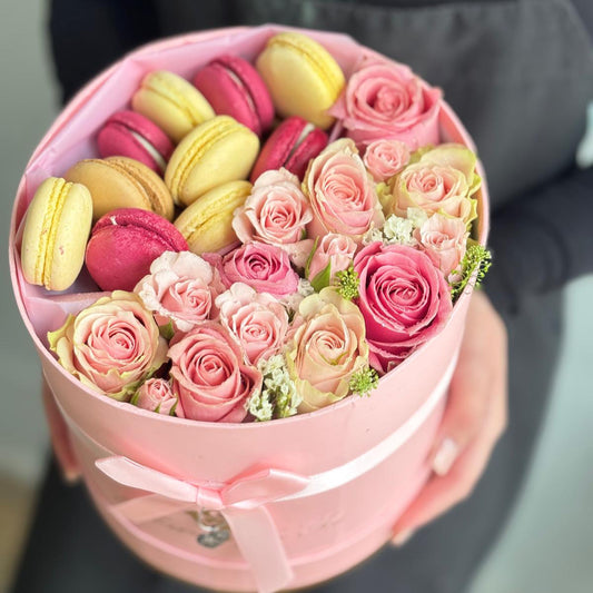 Close-up of a pink rose in full bloom with dewdrops on the petals.