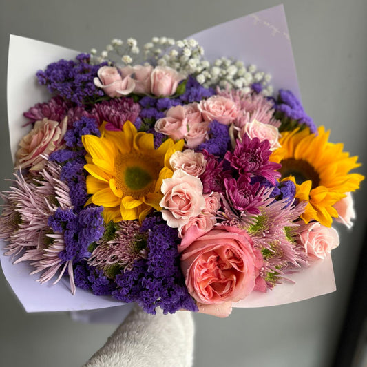Bouquet of colorful flowers on a gray background
