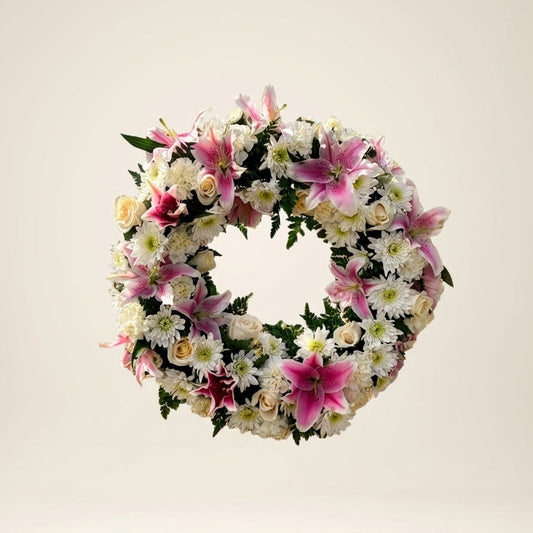 Floral wreath with pink and white flowers on a light background
