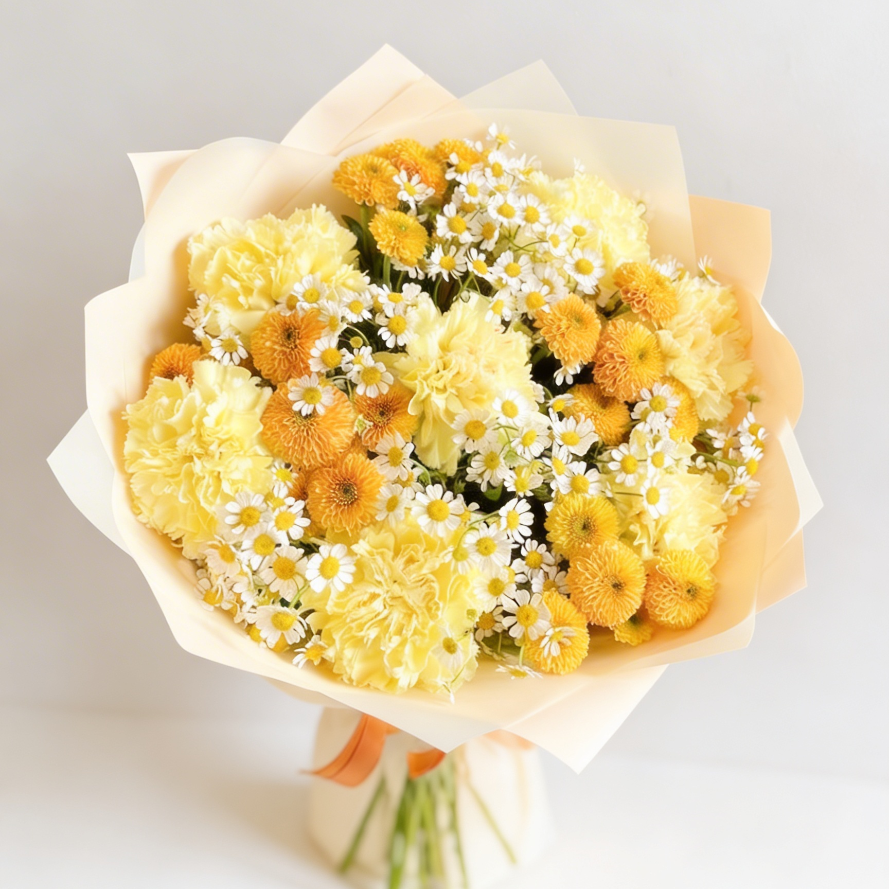 Bouquet of yellow flowers with white accents on a light gray background