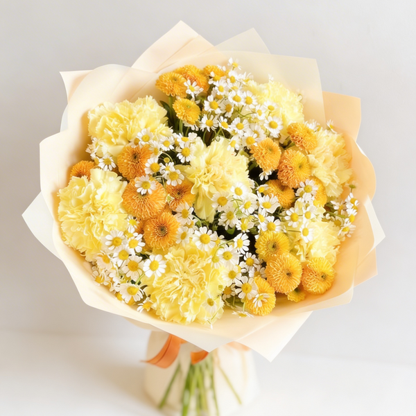 Bouquet of yellow flowers with white accents on a light gray background