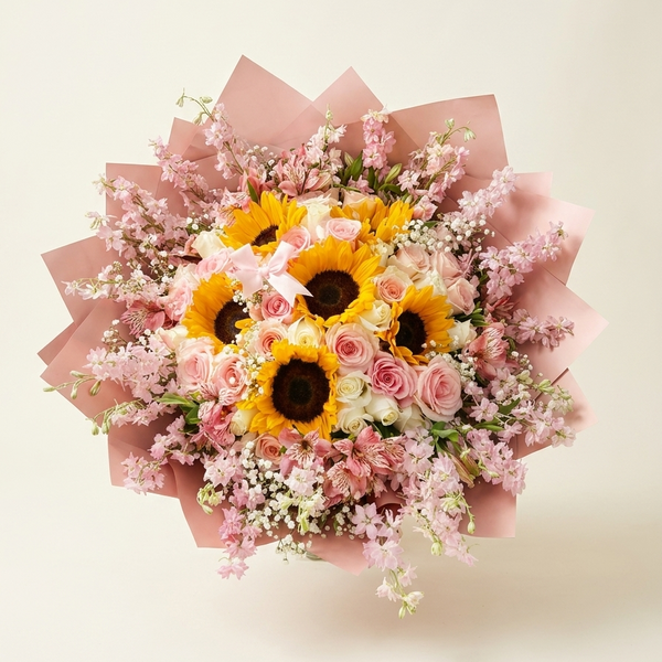 Bouquet of sunflowers and pink roses with pink paper wrap on a light beige background