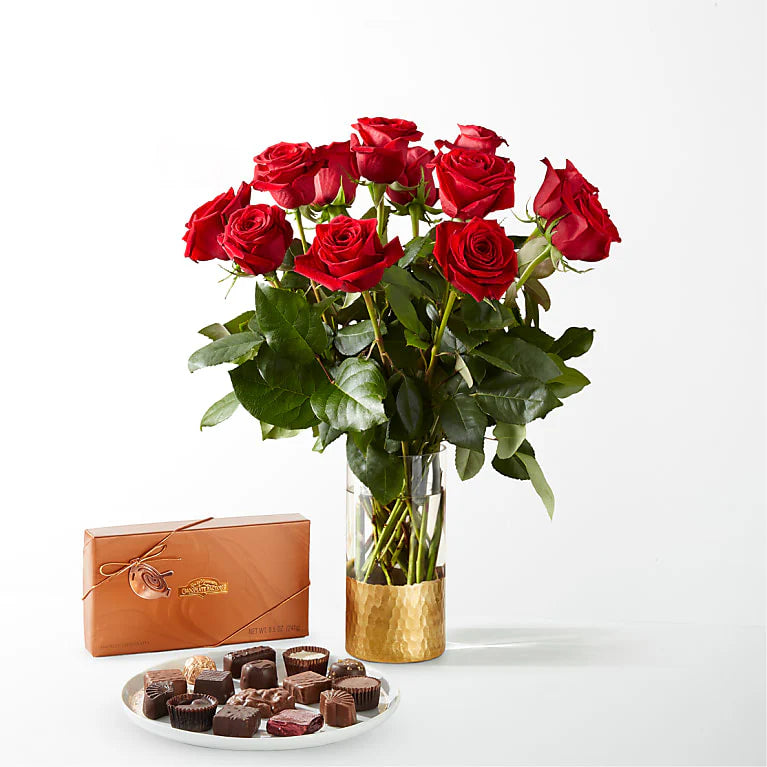 Fresh long-stemmed red roses arranged in a sleek vase, creating a stunning centrepiece for any occasion.