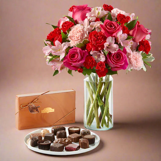 Luxury hot pink vase with a fresh flower arrangement featuring roses, lilies, and tulips, paired with a box of premium chocolates. Perfect gift for birthdays, anniversaries, Mother's Day, or any special occasion.