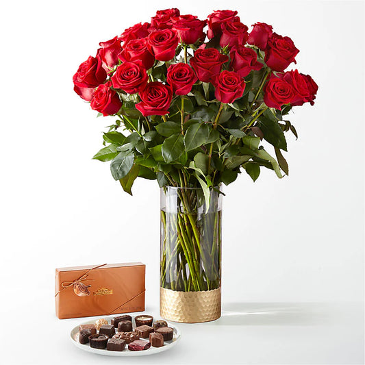 Fresh long-stemmed red roses arranged in a sleek vase, creating a stunning centerpiece for any occasion.