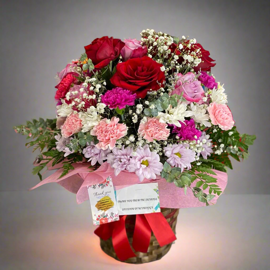 Elegant floral basket with fresh flowers including roses, lilies, and daisies, creating a stunning and thoughtful gift.