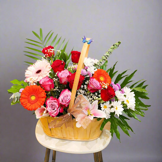 Beautiful Nargialise mixed flower basket featuring a variety of vibrant blooms such as roses, gerberas, lilies, and tulips, arranged in a rustic wicker basket. Perfect for birthdays, anniversaries, thank you gifts, and more